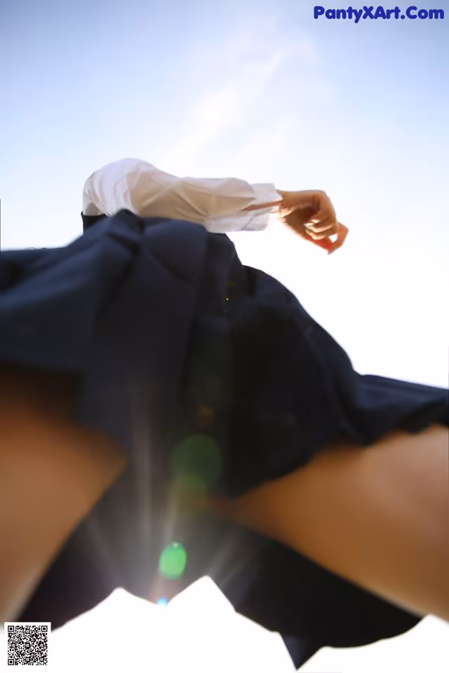 A woman in a black skirt and a white shirt.