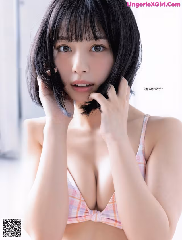 A woman in a pink and white bikini posing for a magazine.