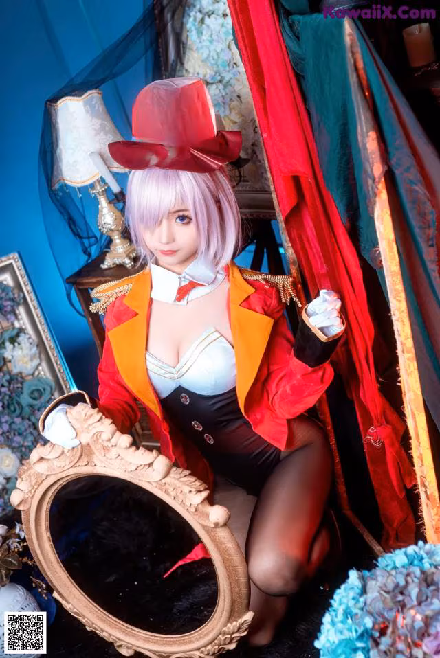 A woman in a top hat sitting in front of a mirror.