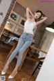 a woman sitting on top of a wooden table